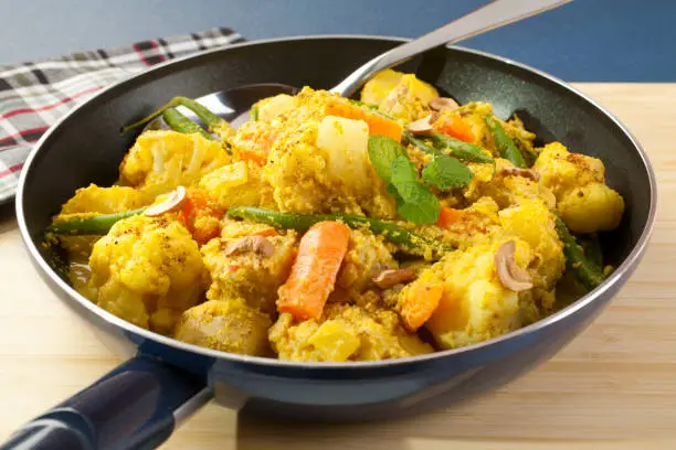 Vegetable Curry - Cauliflower, potatoes, carrots and green beans in a yummy curry sauce with lots of almonds, coriander, onion, ginger and yoghurt. A light and tasty vegetarian meal.