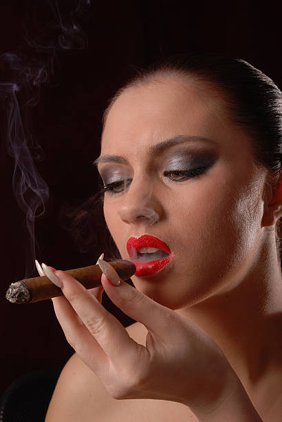 istock Beautiful woman smoking a cigar 106362565
