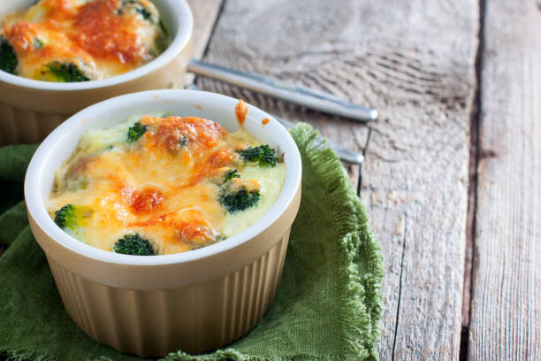 Broccoli baked with cheese in portions, selective focus Broccoli baked with cheese in portions, selective focus seafood gratin stock pictures, royalty-free photos & images