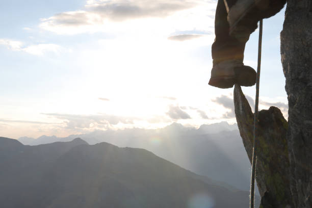 istock Person's legs mountain climbing on steep rock 1063628512