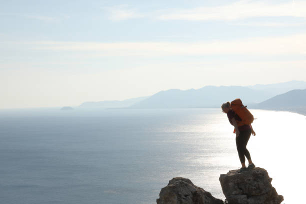 istock Female hiker arrives on summit at sunrise 1063629036