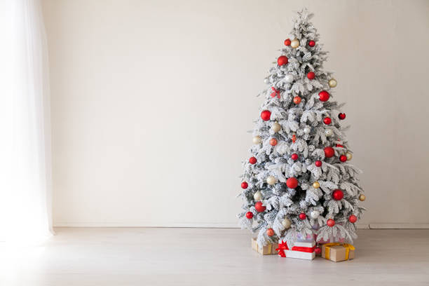 istock Christmas Christmas tree with presents in a white room in winter 1063630878