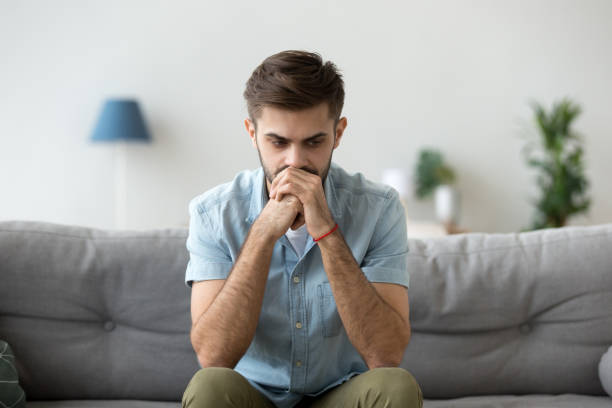 istock Serious pensive man sitting thinking at home 1063637484
