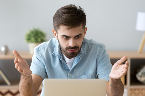 Frustrated Man Looking At Computer Screen Sitting At The Desk Stock Photo -  Download Image Now - iStock