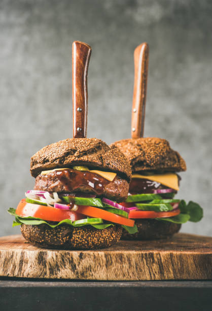 istock Beef meat cheeseburgers with barbeque sauce on board 1063637744