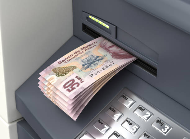 Withdrawal Mexican Pesos From The ATM stock photo