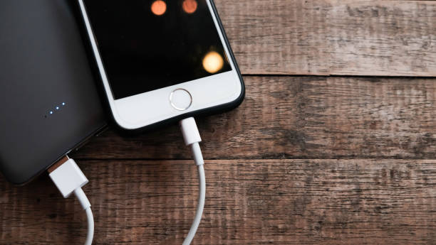 istock Mobile phone connect to power bank. 1063644010