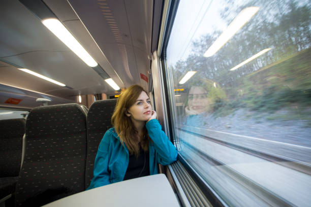 istock Young woman enjoying a train ride 1063647284