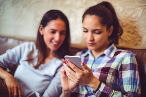 istock Smiling friends with smart phone 1063652148