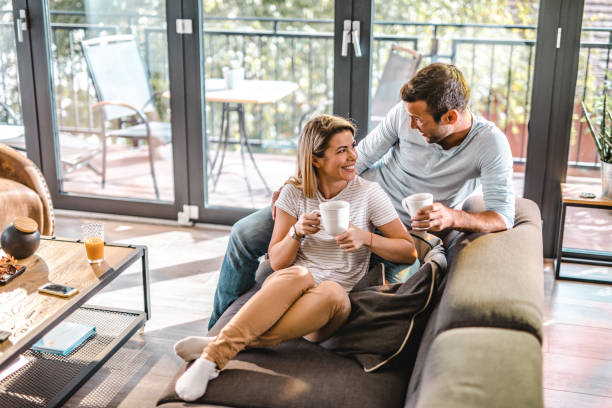 istock Young happy couple talking during coffee time at home. 1063652280