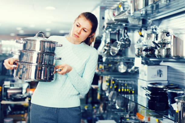 istock Nice female is buying new saucepan 1063659484