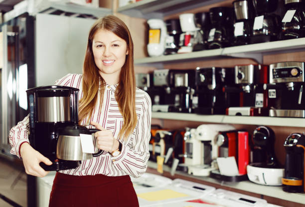 istock woman demonstrating coffee machine 1063659698