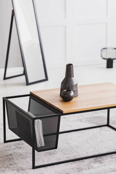 istock Two ceramic vases in different sizes standing on modern coffee table in bright room 1063660088