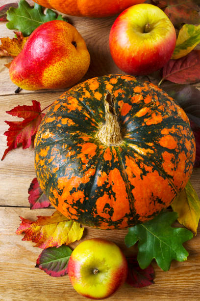 istock Fall decor with pumpkin, apples, pear, red leaves 1063665526