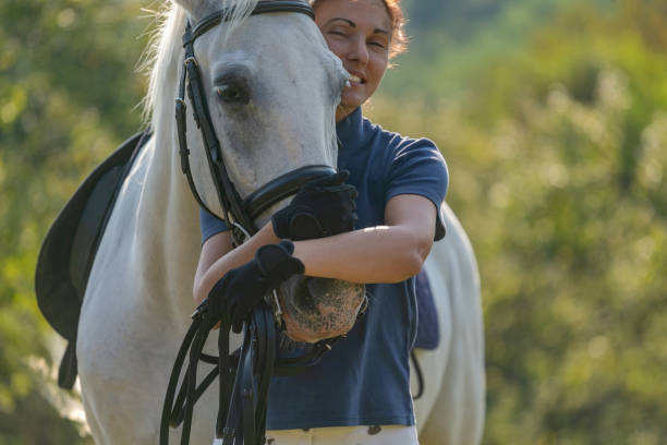istock Woman cuddling with her horse 1063665848