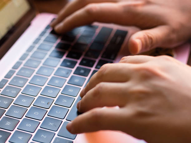 istock Man's hands typing on laptop black keyboard 1063674670