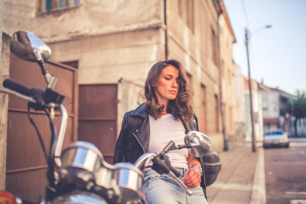 istock Young pretty fashioned girl sitting on her motorcycle 1063674846