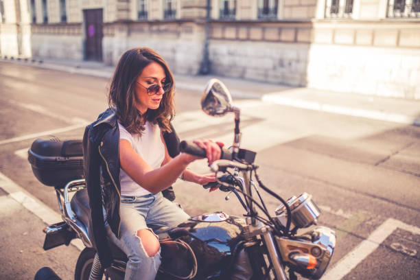 istock Young pretty fashioned girl sitting on her motorcycle 1063676126