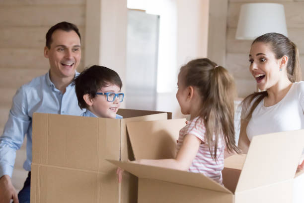 istock Small kids jump out cardboard boxes playing with parents 1063676558