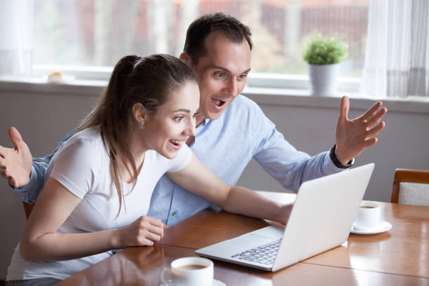 istock Millennial couple excited winning lottery online 1063676580