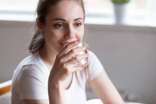 istock Dehydrated woman drinking pure mineral water 1063676686