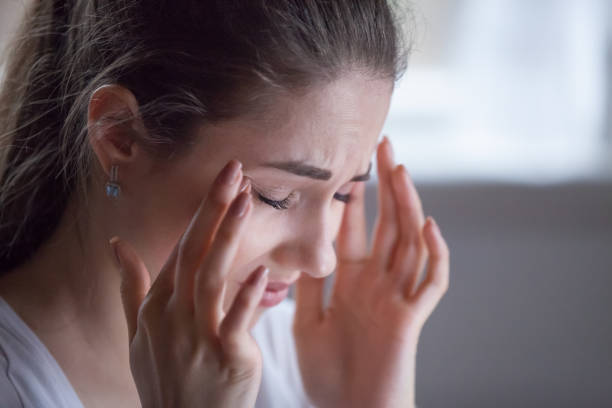 istock Close up of exhausted female suffering from headache 1063676720