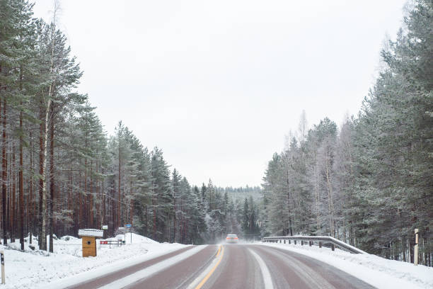 istock Car with lights on a snow covered road. 1063677380