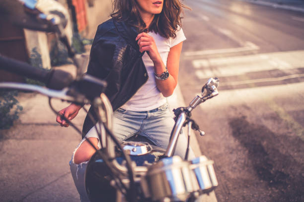 istock Young pretty fashioned girl sitting on her motorcycle 1063677530
