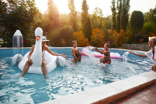 Multi generation family having fun on the pool
