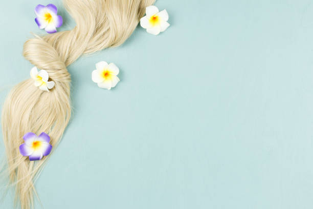 istock Hair extensions on blue wooden background. Top view 1063682632