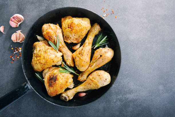 istock Chicken legs roasted in pan served 1063690884
