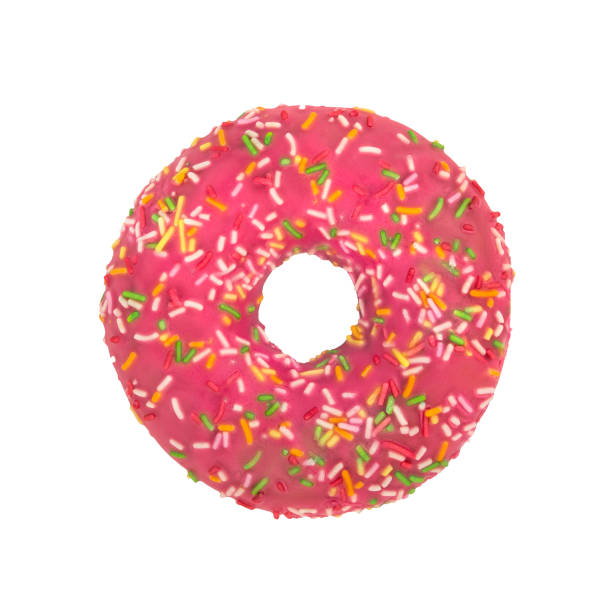 istock Pink donut with colorful sprinkles isolated on white background. Top view. 1063691102