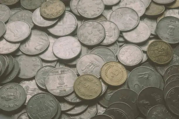 Photo of Stock pile of Hundred number 1, 10, 5 Indian rupee metal coin currency on isolated background.