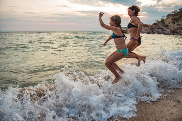 istock Mother and daughter at beach 1063694046