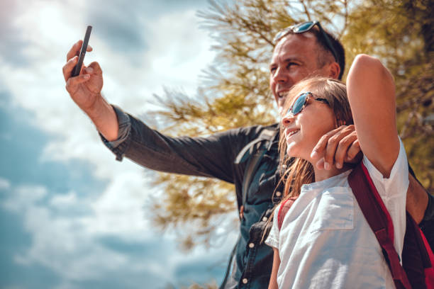istock Father and daughter making selfie with smart phone 1063696438