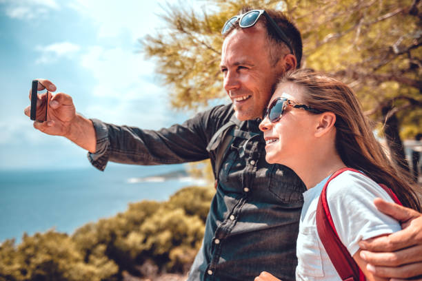 istock Father and daughter making selfie with smart phone 1063697866