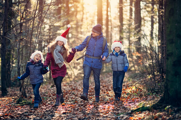 istock Father enjoying walk in forest on Christmas 1063698278
