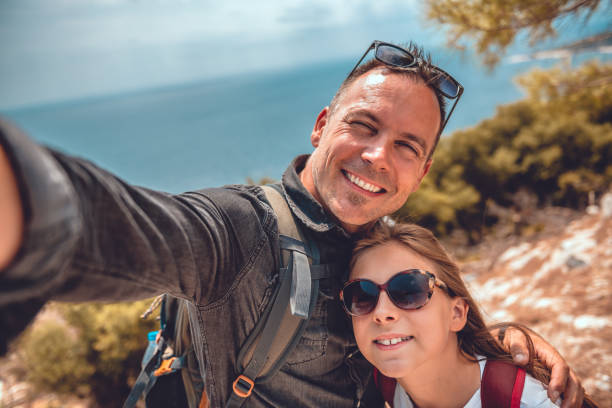 istock Father and daughter making selfie with smart phone 1063700184