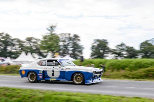 Daun, Germany - July 25/2025: Eifel Rally festival with vintage rally cars on public roads in the Eifel, open hood of an old Opel Kadett C Rally, 1970s version