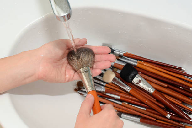 istock makeup artist is rinsing cosmetic brush by water 1063700954
