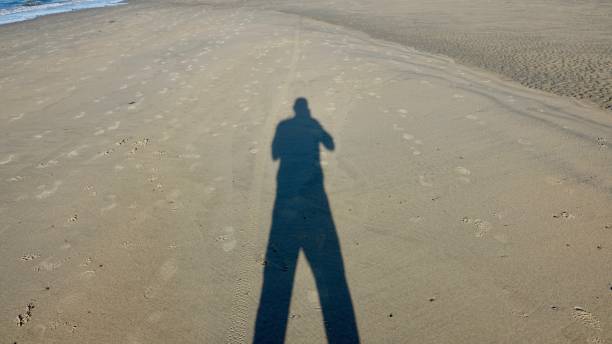 istock Shadow of a person at the beach 1063704590