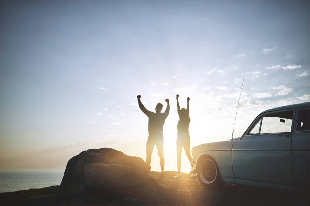 Shot of a young couple making a stop at the beach while out on a road trip