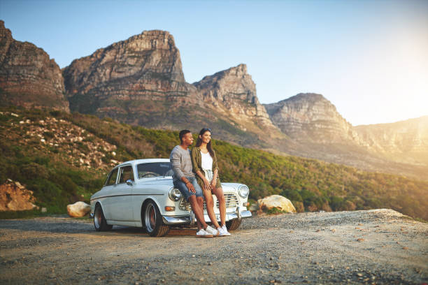 Shot of a young couple making a stop at the beach while out on a road trip