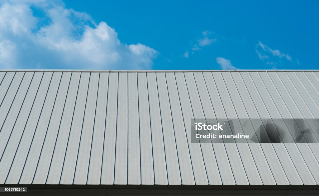 Metal sheet for industrial roof and blue sky. Rooftop Stock Photo