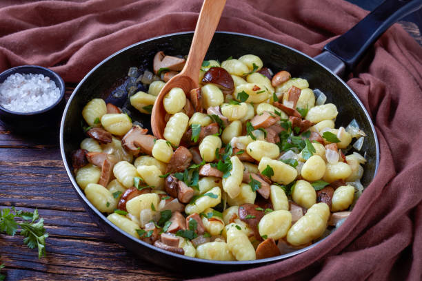 istock Potato gnocchi with mushrooms on a skillet 1063710462