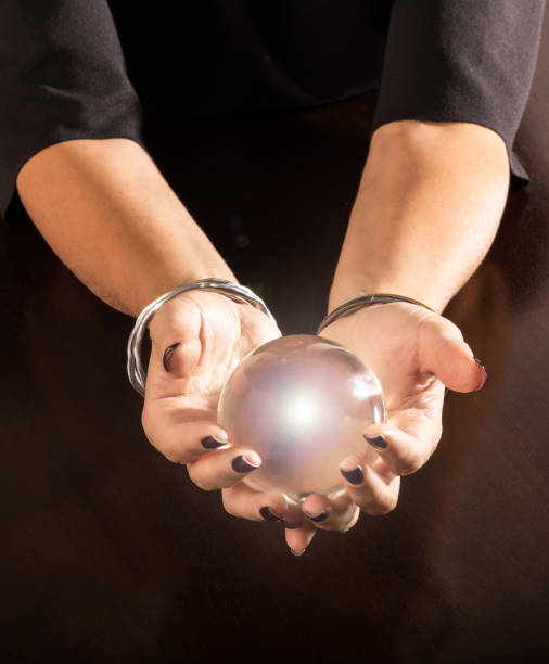 istock Fortune teller holding a crystal ball in her hands 1063710874