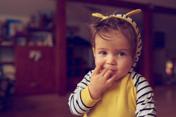 istock baby girl biting fingers 1063712160