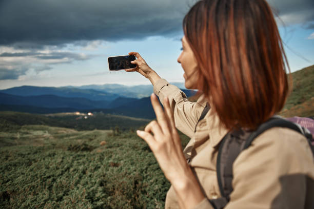 istock Relaxed woman smiling to camera and taking selfies 1063714022