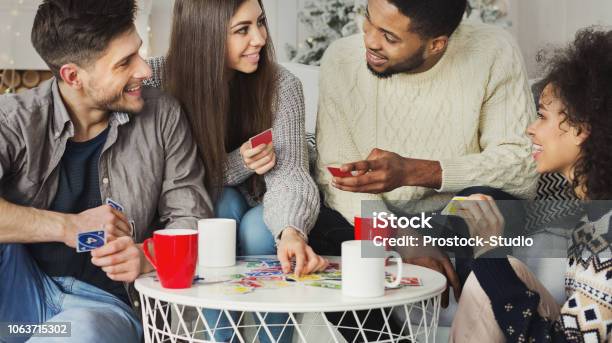 Happy Friends Playing Game Of Cards Uno Stock Photo - Download Image Now - Playing Card, UNO City Complex, Leisure Games