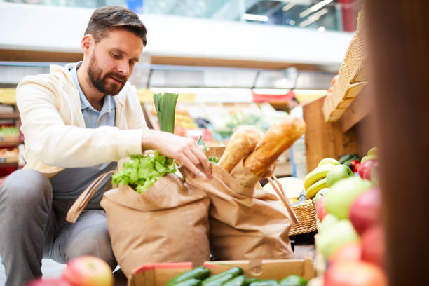istock Handsome man packing products in bags 1063716326